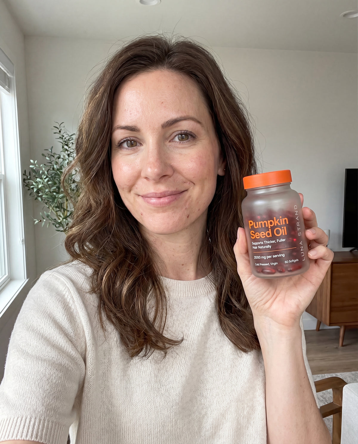 Customer holding Luna Strand Pumpkin Seed Oil